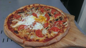 hand stretched pizza dough with home made pizza tomato sauce, tasty mozzarella, mushrooms, bacon, egg, fresh tomato and onion