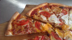 NEW Australiana Pizza - homemade pizza sauce, mozzarella, mushrooms, bacon, egg, fresh tomato, onion